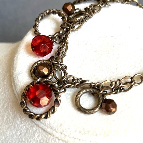 Antiqued brass finish two strand circle red/copper faceted bead charm bracelet. - Picture 2 of 4